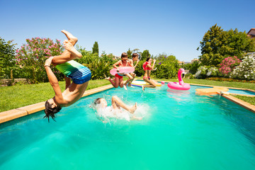 Group of happy teens having fun in swimming pool