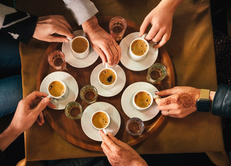 Fototapeta na wymiar Group of people drinking turkish coffey, top view