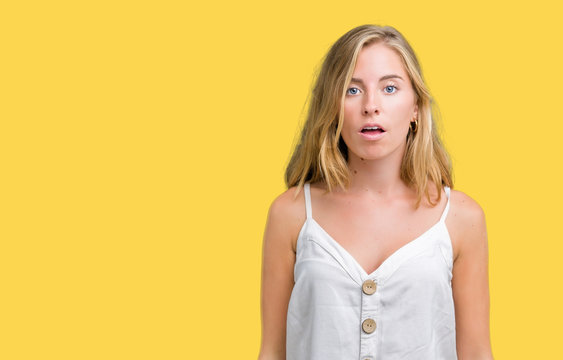 Beautiful young woman over isolated background afraid and shocked with surprise expression, fear and excited face.