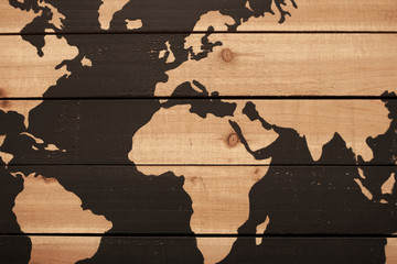Background of rough wood plants with partial view of world map with oceans painted dark brown
