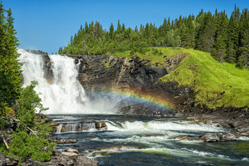 Tannforsen waterfall with summer rainbow