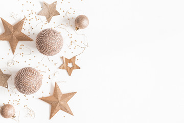 Christmas composition. Christmas golden decorations on white background. Flat lay, top view, copy space