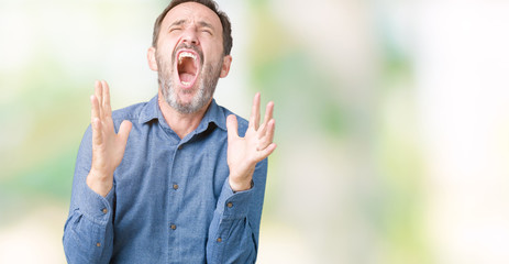 Handsome middle age elegant senior man over isolated background crazy and mad shouting and yelling with aggressive expression and arms raised. Frustration concept.