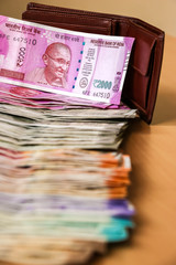 Close up view of leather wallet with brand new indian 10, 50, 100, 200, 500, 2000 rupees banknotes.