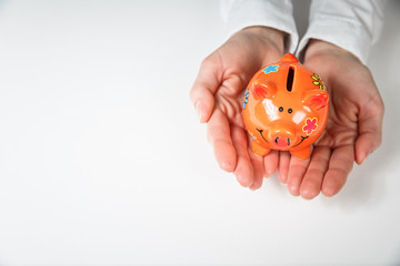 Hand support Piggy Bank, saving money concept.