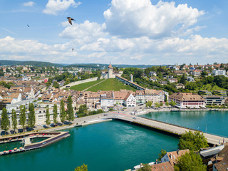 Fototapeta na wymiar Schaffhausen, Switzerland - 14 July 2018: Aerial view of the Swiss old town Schaffhausen, with the medival castle Munot over the Rhine river. Munot is the landmark of this town.