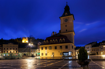 Fototapeta na wymiar The Council Square during rain in Brasov, Romania. View with fam