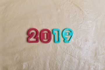 the inscription in the form of 2019 on the raw dough, made up of molds for biscuits. The symbol of the coming 2019.