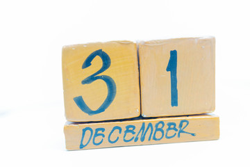 December 31st. Day 31 of month, calendar on wooden background. Handmade calendar