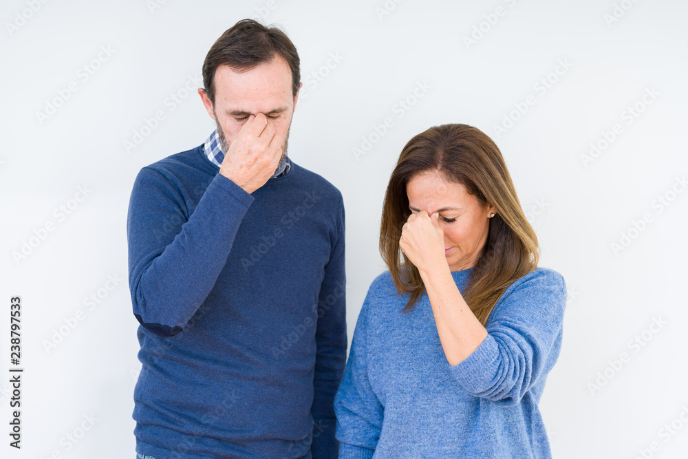 Poster beautiful middle age couple in love over isolated background tired rubbing nose and eyes feeling fat