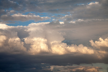 Sunlit storm clouds building over the desert