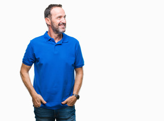Fototapeta premium Middle age hoary senior man over isolated background looking away to side with smile on face, natural expression. Laughing confident.