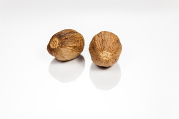 Nutmeg isolated on white reflective surface