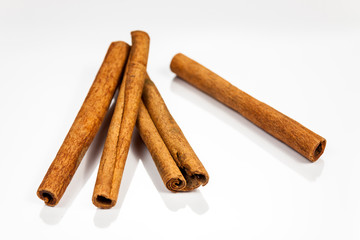 Cinnamon isolated on white reflective surface