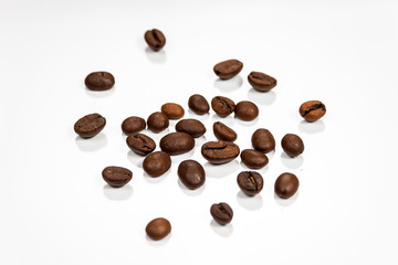 Coffe beans isolated on reflective white surface