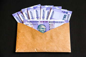 Close up view of envelope with brand new indian one hundred rupees banknotes.