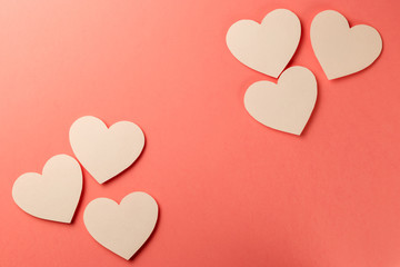 Valentine's Day postcard. Valentine's Day Background. Heart on coral background. Copy space. Top view. Flat lay. Pastel colors. Living Coral color of the Year 2019