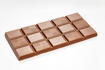 Chocolate bar isolated on white reflective background