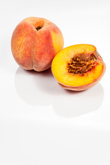 Peach isolated on white reflective background