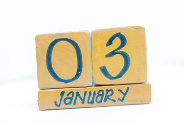 January 3rd. Day 3 of month, calendar on wooden background. Winter time, year concept.