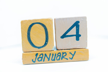 January 4th. Day 4 of month, calendar on wooden background. Winter time, year concept.