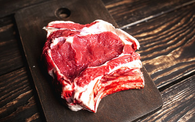 fresh raw beef steak on wooden cutting board