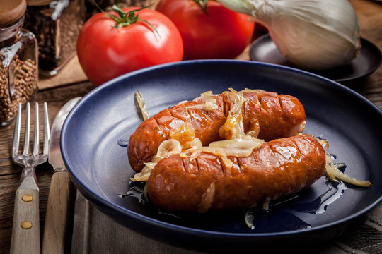 Fried sausage with onions.