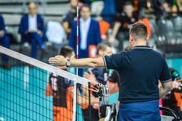 Volleyball referee gives sign who score the point