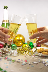 Toast between two glasses at a Christmas celebration