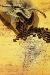 coffee beans scattered on an old map of South America