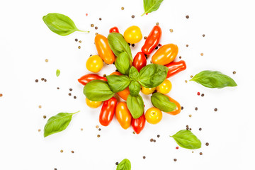 Centered composition of basil, pepper and cherry tomatoes, on white background