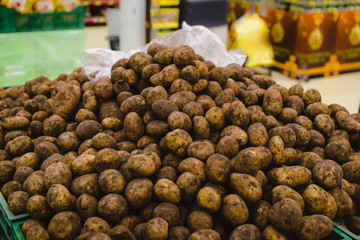 Closeup of a pile of potatoes on the box in the supermarket