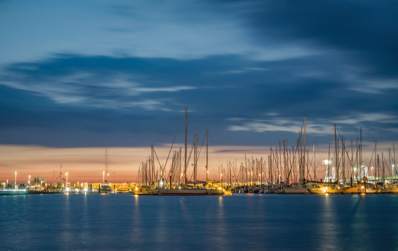 Yacht harbor of Cuxhaven Germany at sunset with water reflections.