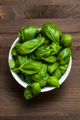 Basil in the pot isolated on wooden background