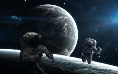 Astronauts, planets, deep space landscape in light of a blue star. Science fiction art. Elements of the image were furnished by NASA