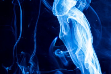 Fototapeta premium Blue smoke on black background