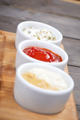 different sauces on the wooden background