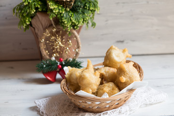 Tipical Christmas apulian Food Called Pettole on Blur Cristmas Decorations Background