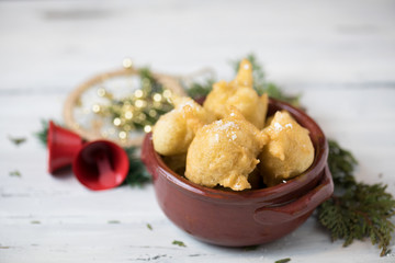 Close up of a Traditional Christmas Italian Food Called Pettole on Blur Cristmas Decorations...