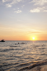 Local kids are playing in the water at sunset on Phu Quoc in Vietnam