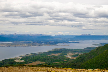 Fototapeta premium Landscape with forest, Beagle Channel and isolated houses as seen from Cerro Bandera, Puerto Williams, Chile