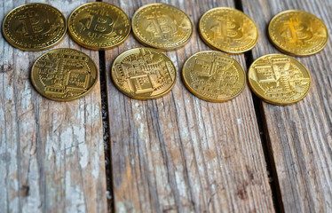 Gold Bitcoin money on wooden table. Electronic crypto currency