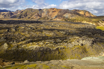 Panoramic view over the lava field of Laugahraun and the colorful mountains of Landmannalaugar, Iceland, seen from the volcano of Blahnukur.