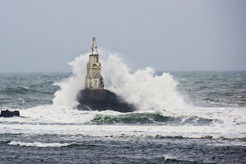 Storm wave at sea lighthouse. Ahtopol, Bulgaria