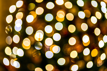 Christmas home room with tree and festive bokeh lighting, blurred holiday background