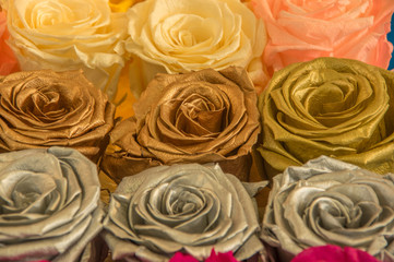 Close up of selective focus of beautiful roses with metallic, golden colors in a bunch