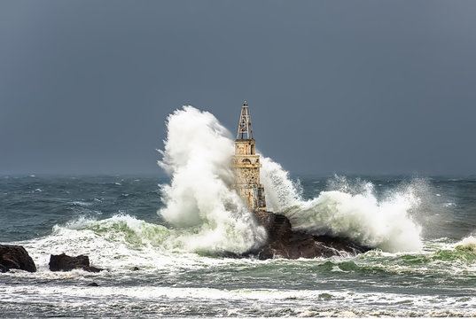 Storm wave at sea lighthouse. Ahtopol, Bulgaria