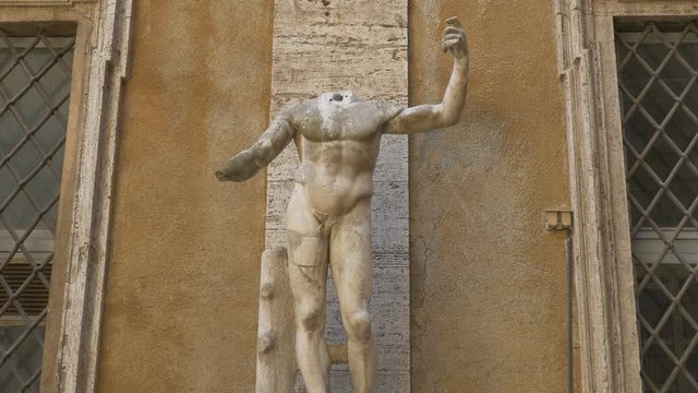 Headless figure. Handheld stabilized shot. Rome, Italy.