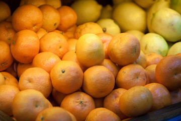 A lot of tangerines counter. fruit at the grocery store. sale and discounts