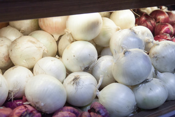 A lot of onion counter. fruit at the grocery store. sale and discounts